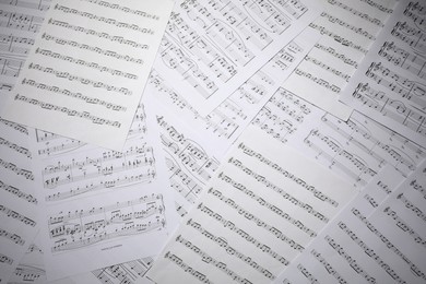Photo of Sheets with musical notes as background, top view