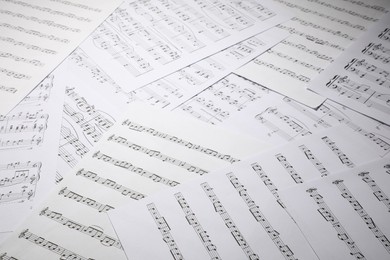 Photo of Sheets with musical notes as background, closeup