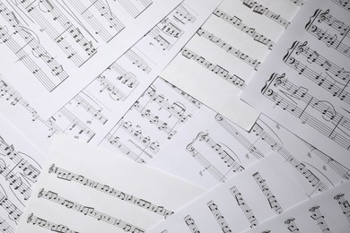 Photo of Sheets with musical notes as background, closeup