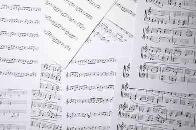 Photo of Sheets with musical notes as background, top view