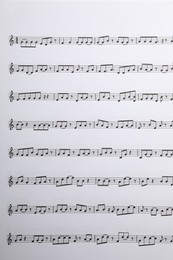 Photo of Sheets with musical notes as background, top view