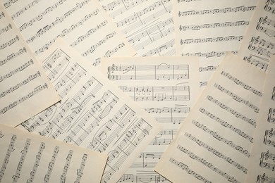 Photo of Sheets with musical notes as background, top view