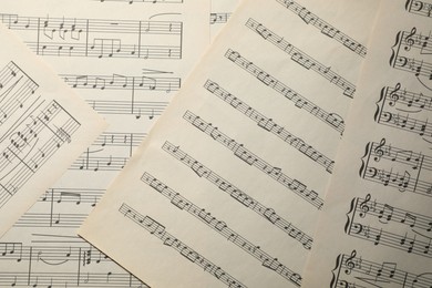 Photo of Sheets with musical notes as background, top view