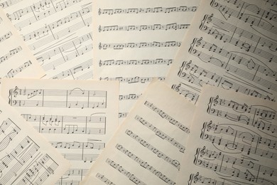 Photo of Sheets with musical notes as background, top view