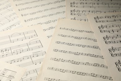 Photo of Sheets with musical notes as background, closeup