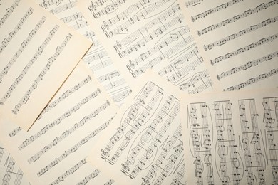 Photo of Sheets with musical notes as background, top view