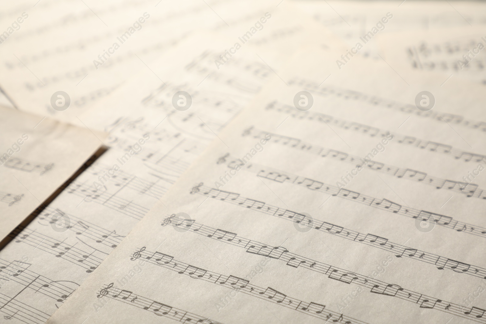 Sheets with musical notes as background, closeup Photo of Sheets with musical notes as background, closeup