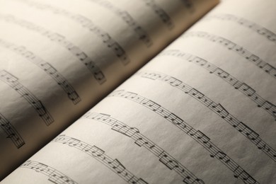 Photo of Sheets with musical notes as background, closeup
