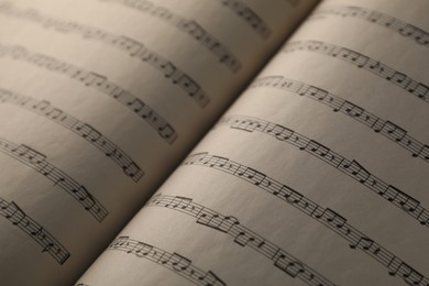 Photo of Sheets with musical notes as background, closeup