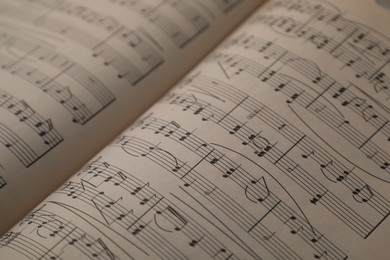 Photo of Sheets with musical notes as background, closeup