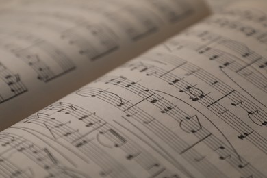 Photo of Sheets with musical notes as background, closeup