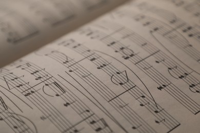 Photo of Sheets with musical notes as background, closeup