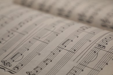 Photo of Sheets with musical notes as background, closeup