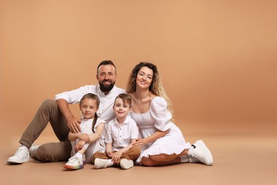Photo of Happy family posing on beige background. Space for text