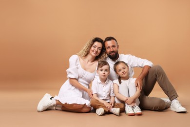 Photo of Happy family posing on beige background. Space for text