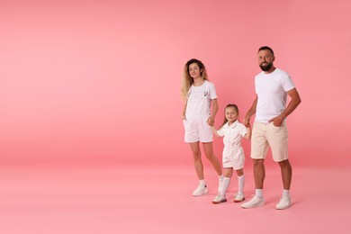 Photo of Happy family on pink background. Space for text