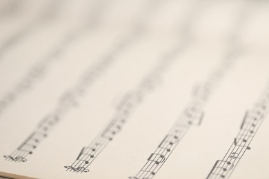 Photo of Sheet with musical notes as background, closeup