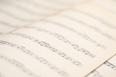 Photo of Sheets with musical notes as background, closeup