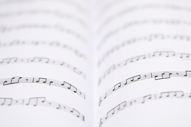 Photo of Sheets with musical notes as background, closeup