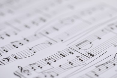 Photo of Sheet with musical notes as background, closeup