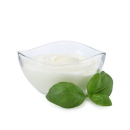 Photo of Tasty yoghurt in bowl and basil isolated on white