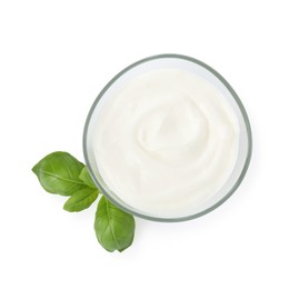 Photo of Tasty yoghurt in bowl and basil isolated on white, top view