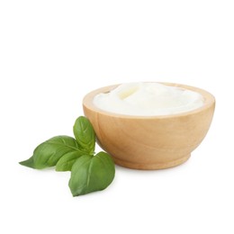 Photo of Tasty yoghurt in bowl and basil isolated on white