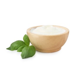 Photo of Tasty yoghurt in bowl and basil isolated on white