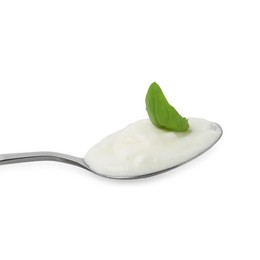 Photo of Tasty yoghurt with basil in spoon isolated on white