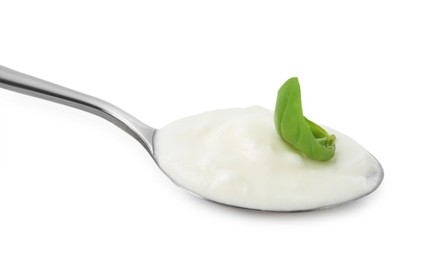 Photo of Tasty yoghurt with basil in spoon isolated on white