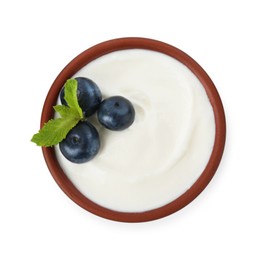 Photo of Tasty yoghurt with blueberries and mint in bowl isolated on white, top view