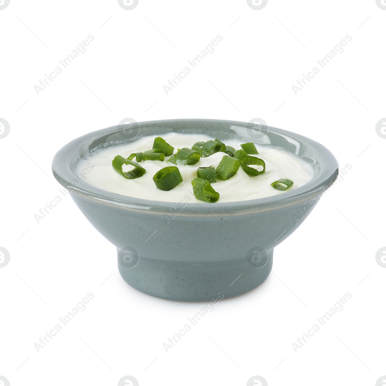 Tasty yoghurt with green onions in bowl isolated on white Photo of Tasty yoghurt with green onions in bowl isolated on white
