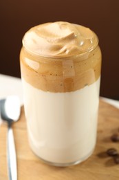 Photo of Delicious dalgona coffee in glass on table, closeup
