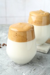 Photo of Delicious dalgona coffee in glasses on grey table, closeup