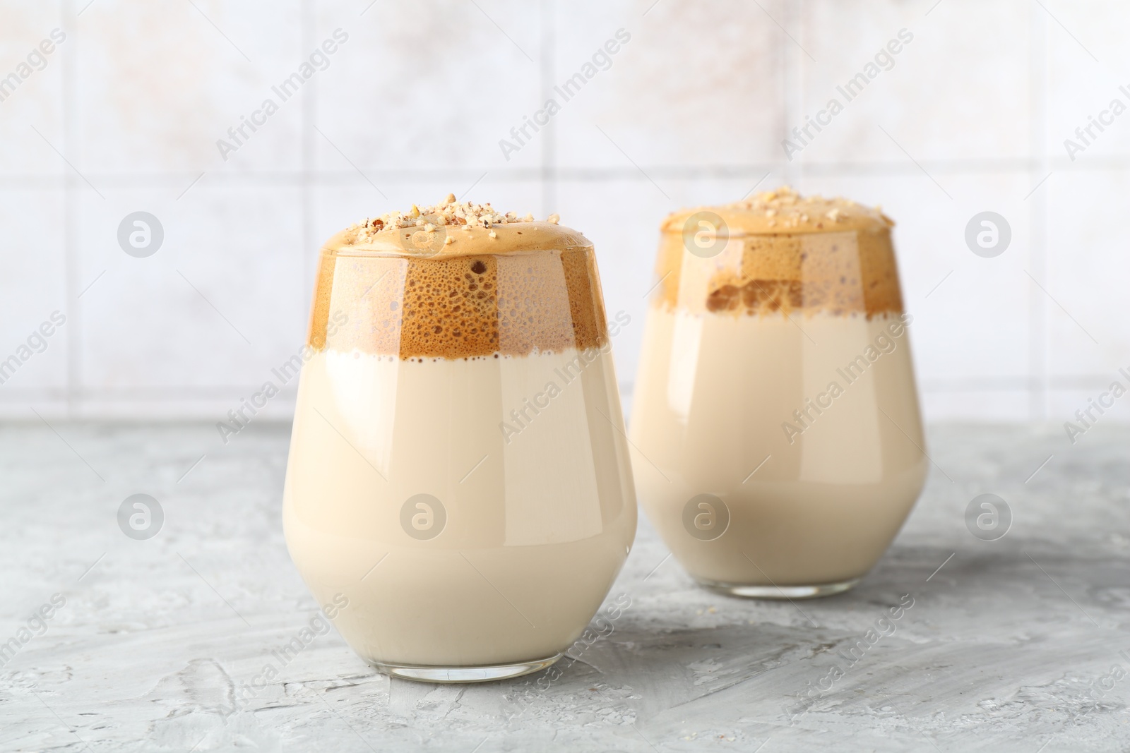 Photo of Delicious dalgona coffee in glasses on grey table, closeup
