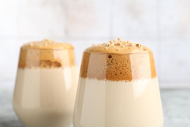 Photo of Delicious dalgona coffee in glasses on table, closeup