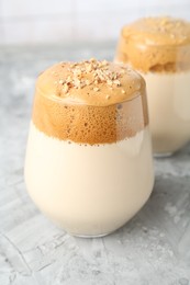 Photo of Delicious dalgona coffee in glasses on grey table, closeup