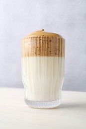 Photo of Delicious dalgona coffee in glass on light table, low angle view