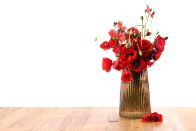 Photo of Beautiful red poppy flowers in vase on wooden table against white background