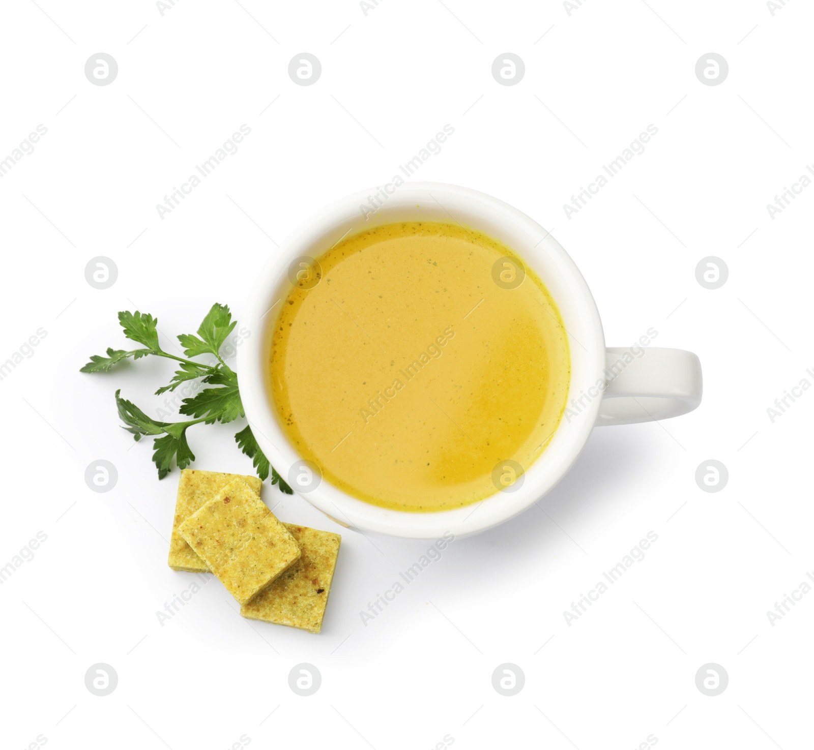Aromatic bouillon cubes, broth and parsley isolated on white, top view Photo of Aromatic bouillon cubes, broth and parsley isolated on white, top view