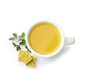 Photo of Aromatic bouillon cubes, broth and parsley isolated on white, top view