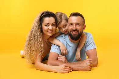 Photo of Portrait of happy family on yellow background