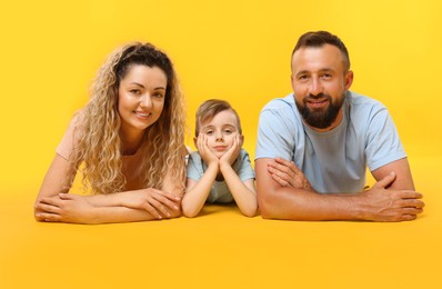 Photo of Portrait of happy family on yellow background