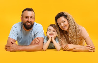 Photo of Portrait of happy family on yellow background
