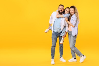 Photo of Happy family on yellow background. Space for text