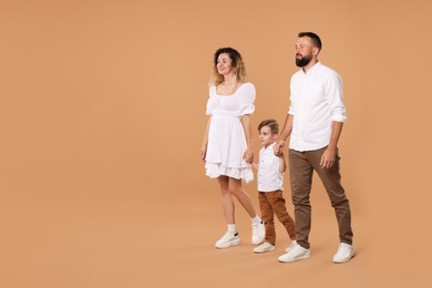Photo of Happy family on beige background. Space for text