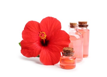 Photo of Beautiful red hibiscus flower and cosmetic products isolated on white