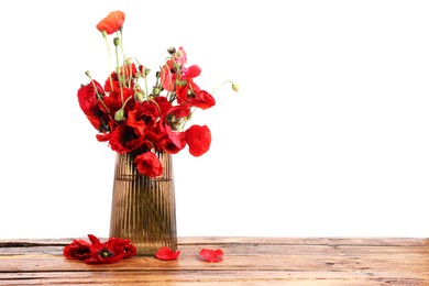 Photo of Beautiful red poppy flowers in vase on wooden table against white background