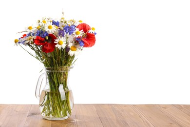 Photo of Beautiful wildflowers in vase on wooden table against white background