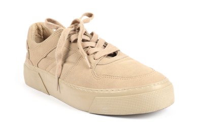 Photo of One stylish beige sneaker on white background
